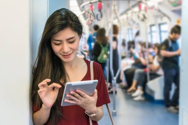 Asyalı kadın yolcu tablet ile 