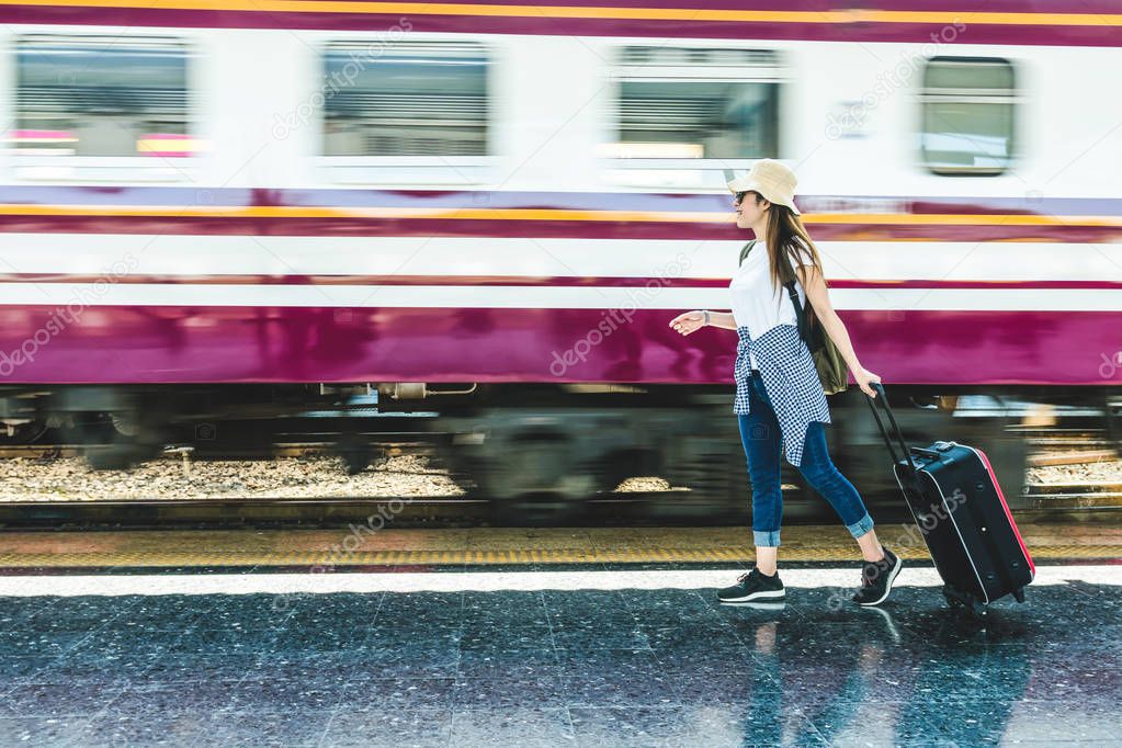 woman traveler holding suitcase