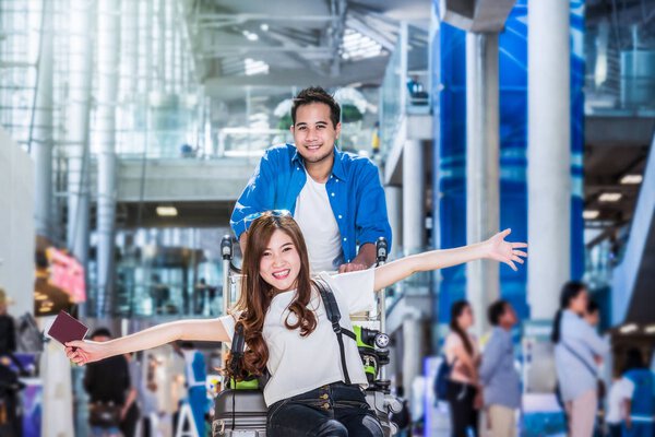 couple traveler with suitcases at airport.