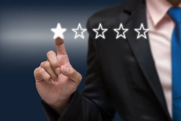Businessman pointing five star symbol 