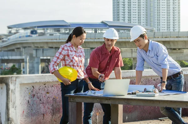 Group of professional engineers with blueprints — Stock Photo, Image