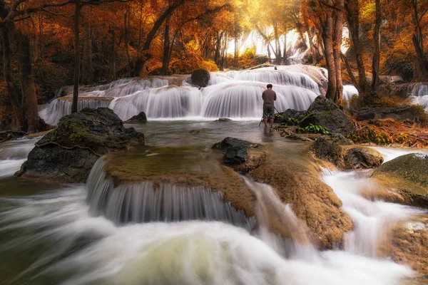 Photographer taking photo  of  waterfall 