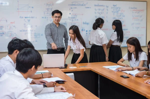 Asian teacher Giving Lesson
