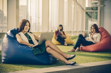 Üç Asyalı kadınlar sosyal kullanarak modern yaratıcı ofis, iş sosyal ağ kavramı her teknoloji ekipmanları ağ