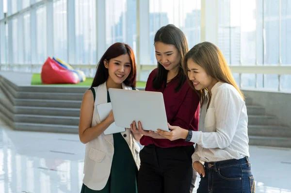 Group Of Asian Businesswomen Meeting In the modern creative Office,closeup at laptop