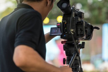 Arka yan sahne, olay ve seminer üretim ekipmanları kavramı için Video kameraman alarak fotoğrafın