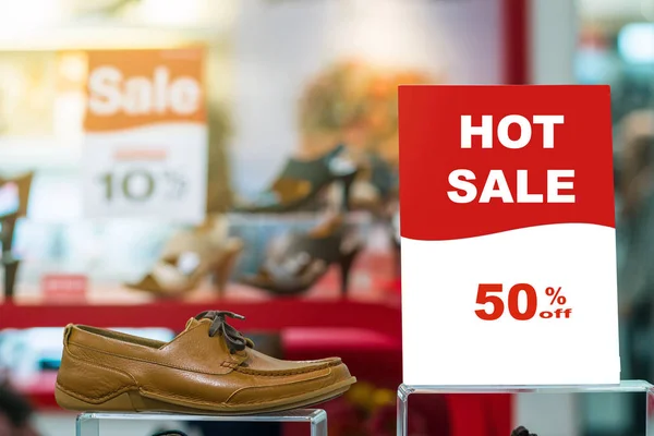 Sale 50% off mock up advertise display frame setting over the men shoes shelf in the shopping department store for shopping, business fashion and advertisement concept