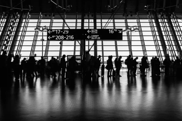 SHANGHAI, CHINA - MAR 2019 : Silhouette of Unrecognizable crowd passenger and tourist walking to the boarding gate in rush hour at Pudong international airport terminal on March 13,2019,Shanghai,China