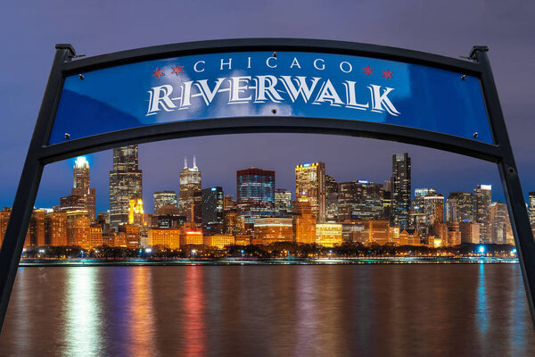The landmark Chicago riverwalk label over Cityscape river side along Lake Michigan at beautiful twilight time, Illinois, United States, Business Architecture and building with tourist concept