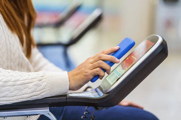 Closeup passenger hand holding and scanning mobile phone with qr code scanner machine of message chair in airport, Technology with travel and tourist, check-in self service,transportation concept,