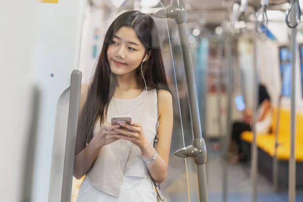 Young Asian Woman Passenger Listening Music Smart Mobile Phone Subway — Stock Photo, Image