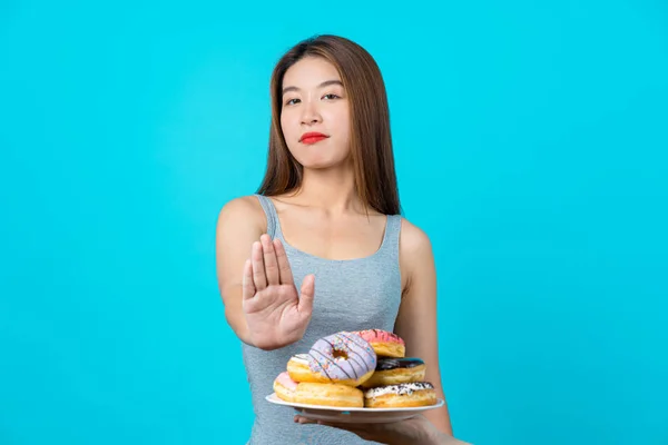 Attractive Asian Young Woman Doing Action Donuts Isolated Blue Color — Stock Photo, Image