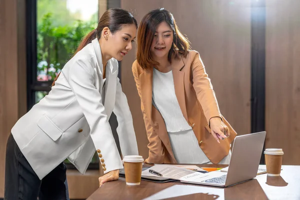 在现代会议室 办公室或工作空间 咖啡休息时间 伴侣和同事概念中 两名亚洲女商人通过技术笔记本电脑与伙伴企业合作 — 图库照片