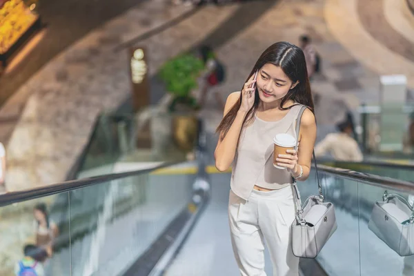 Young Asian Woman Passenger Using Smart Mobile Phone Walking Escalator — 스톡 사진