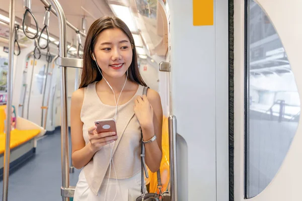 Young Asian Woman Passenger Listening Music Smart Mobile Phone Subway — Stock Photo, Image