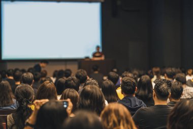 Asyalı izleyicilerin seminer salonunda veya konferans salonunda, eğitim ve atölyede, ortak ve girişim konseptinde sahneye katılıp konuşmacı olarak konuşmalarının arka görüşü