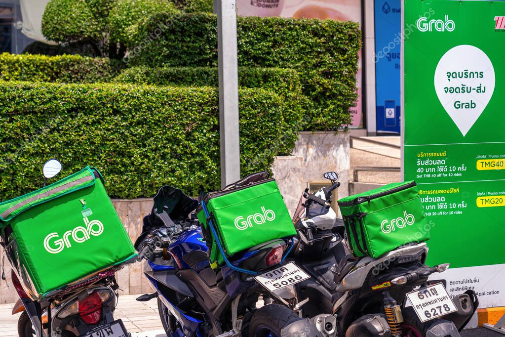BANGKOK, THAILAND - APRIL 2020 : Grab Food Logo on Food boxes on the motorcycles at Food delivery service point on April 17, 2020, Bangkok Thailand,Covid19 outbreak Making food delivery services Popular