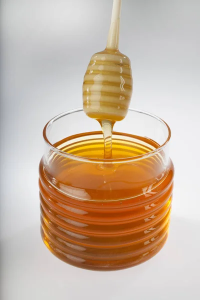 Honey jar with stick — Stock Photo, Image