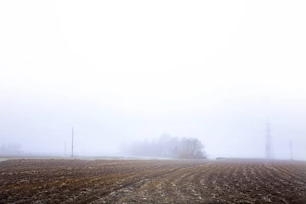 Landscape in heavy fog with plowed land — Stock Photo, Image