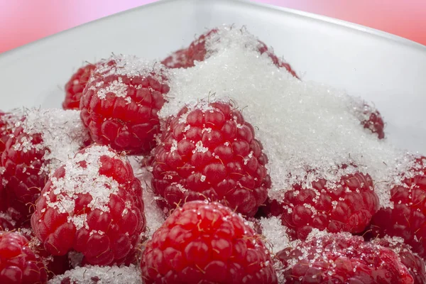 Raspberries in a glass bowl — Stock Photo, Image