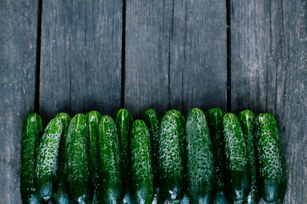 Cucumbers on wooden surface. Seasonal vegetables. Fresh vegetables. Healthy diet. Copy space