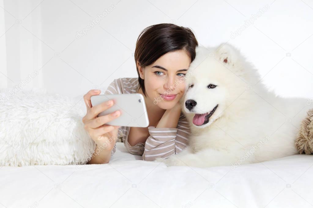 smiling woman with pet dog. selfie