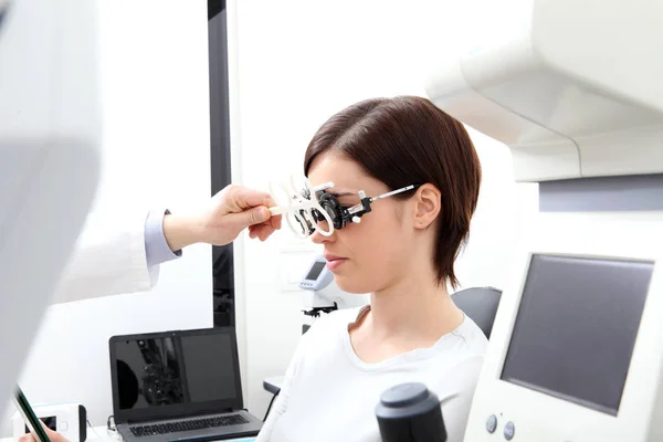 Óptico con marco de ensayo, médico optometrista examina la vista — Foto de Stock