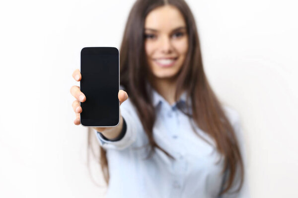happy smiling woman showing mobile phone isolated in white backg
