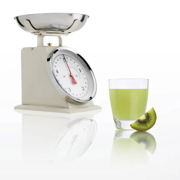 Balança de peso com vidro de suco de kiwi isolado em fundo branco, conceito de dieta equilibrada — Fotografia de Stock