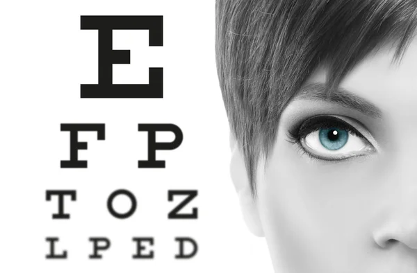 Blue eyes close up on visual test chart, eyesight and eye examin — Stock Photo, Image