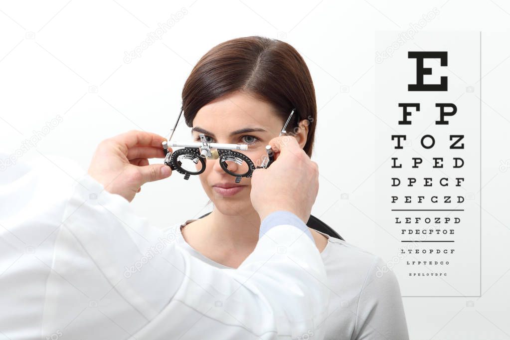 woman doing eyesight measurement with trial frame and visual test