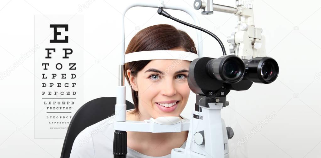 smile woman doing eyesight measurement with slit lamp and visual