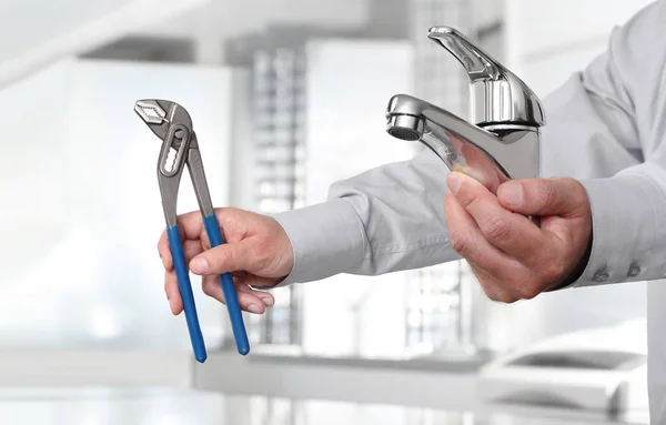 Hands with faucet and pipe wrench, install and construction home — Stock Photo, Image