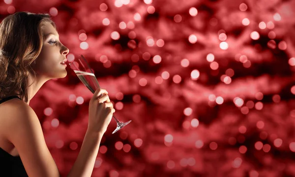 Toast New Year's Eve, woman drinking sparkle wine on red — Stock Photo, Image