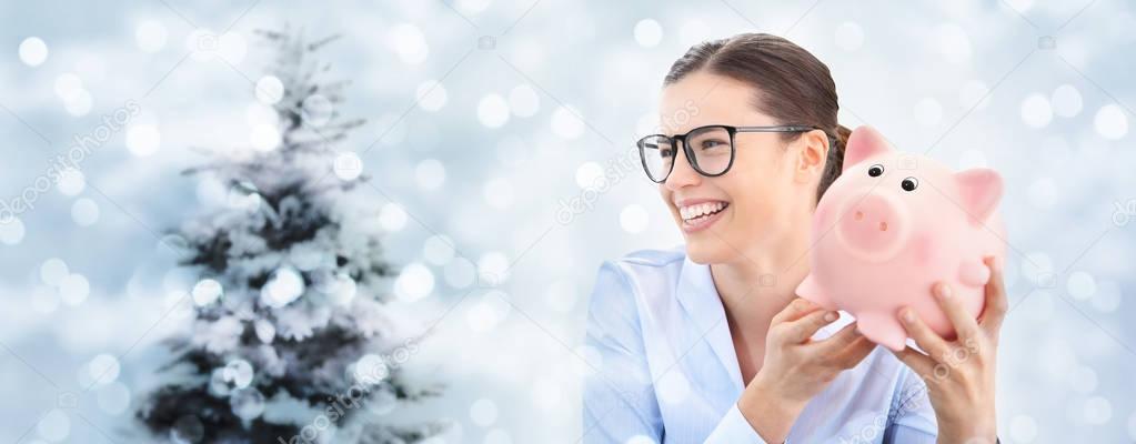 christmas shopping, laughing fun woman with piggy bank isolated 