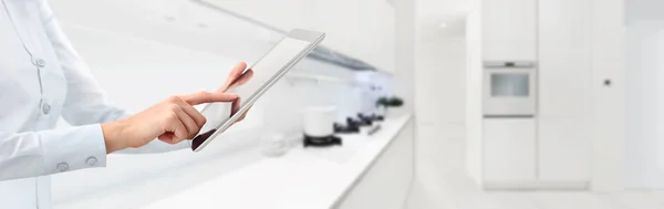 Manos tocan la tableta digital en fondo de cocina casa inteligente — Foto de Stock