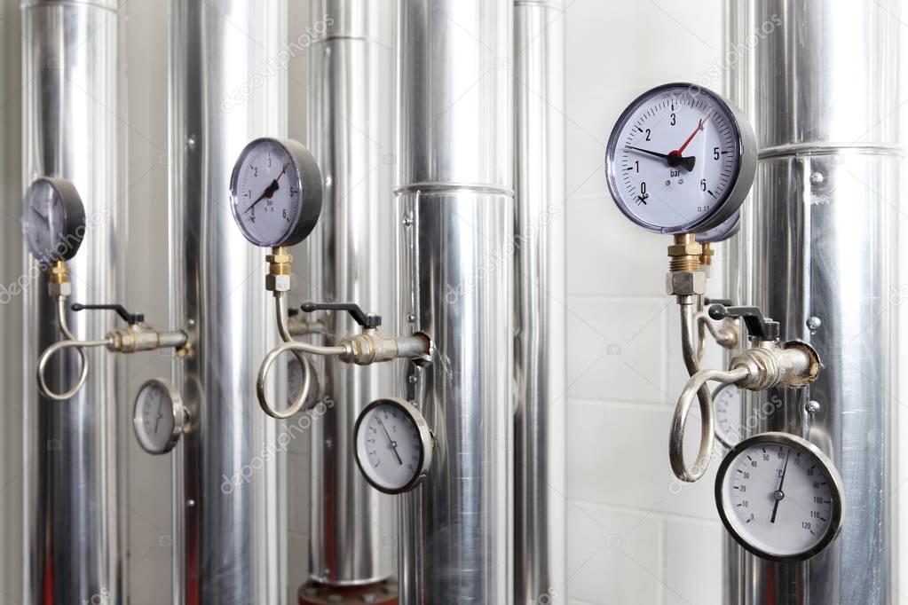 manometer, pipes and faucet valves of heating system in a boiler