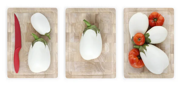 Белые баклажаны и помидоры на деревянной доске — стоковое фото