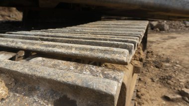 Kazı makinesinin tekerlekleri yere sabitlenmiş. Daha iyi performans için bakım süreci gereklidir