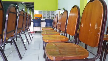 Rows of queue chairs at a health clinic, where patients sit their turn to be examined by a doctor