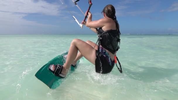 MOCIÓN LENTA CERRAR: Surfista hembra haciendo kite agua de arranque y kite surfs lejos — Vídeo de stock