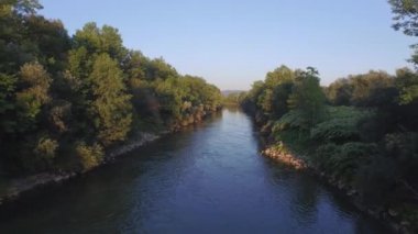 Anteni: Geniş yeşil nehir kayalık ve büyümüş yemyeşil nehir kıyısı ile