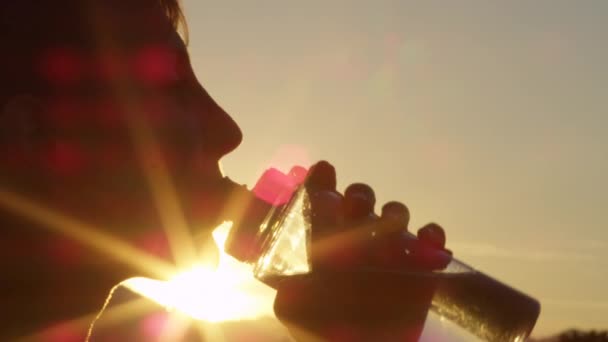 CLOSE UP: Portrait of cute young woman drinking fresh water from plastic bottle — Stock Video