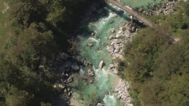 АЭРИАЛ: Бурлящая бирюзовая река и белые пороги, протекающие в скалистом русле реки — стоковое видео