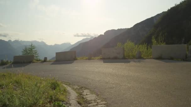 MOCIÓN LENTA: Motociclista de carretera masculino que desciende a toda velocidad por el pintoresco camino de asfalto . — Vídeos de Stock