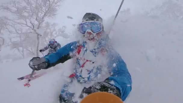 SLOW MOTION: Male tourists having fun skiing in the untouched mountain terrain. — Stock Video