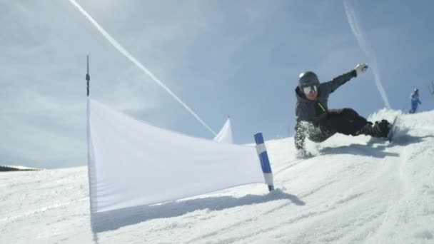 Zpomalené zblízka: Snowboardista závodní jízdě slalomu mezi branami — Stock video