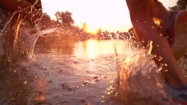 SUN FLARE: Sporty couple jogging in the serene nature at stunning golden sunrise