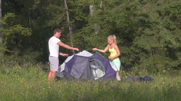 Zeitraffer: Junges Touristenpaar baut erfolgreich auf und steigt ins Zelt. — Stockvideo