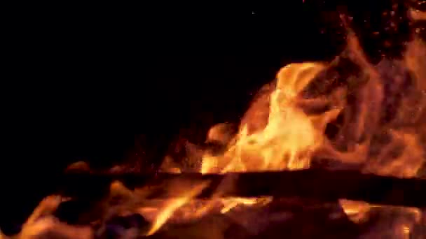 TIME REMAP, MACRO: Unknown person strikes a glowing campfire with a long branch. — Stock Video